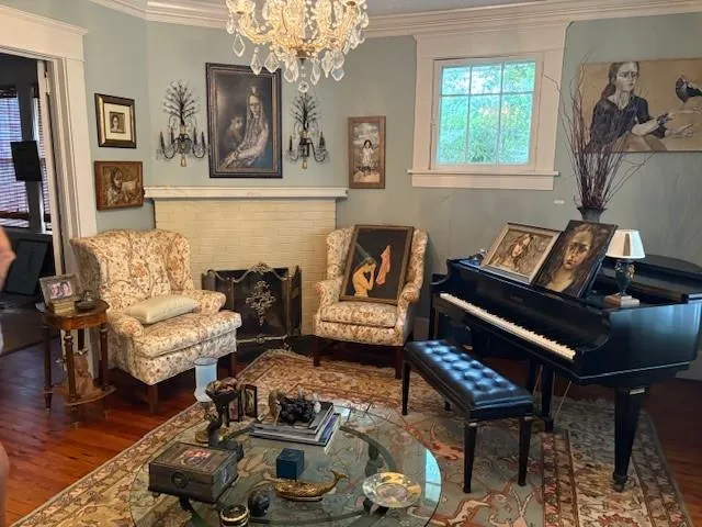 a living room with furniture and a chandelier