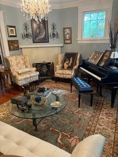 a living room with furniture and a piano