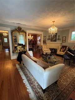 a living room with furniture and a chandelier