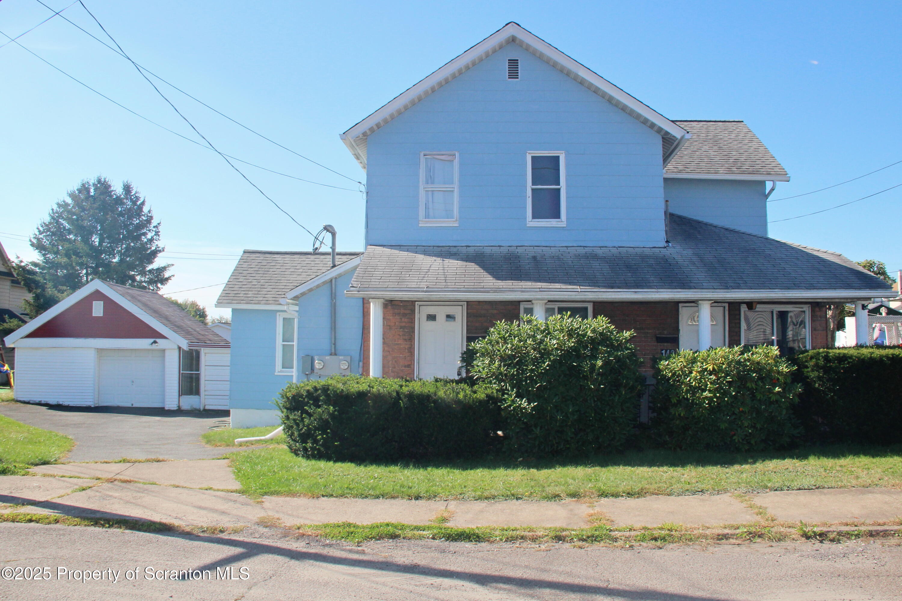 144 East Grace Street Old Forge, PA 18518 - Photo 1 of 17 a front view of a house with a yard and garage
