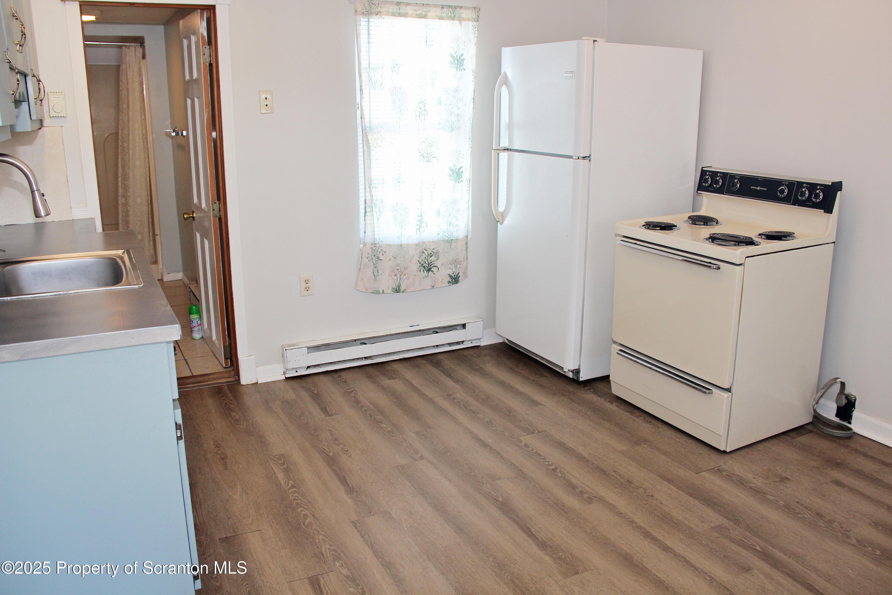 144 East Grace Street Old Forge, PA 18518 - Photo 14 of 17 a view of a kitchen with wooden floor and a sink