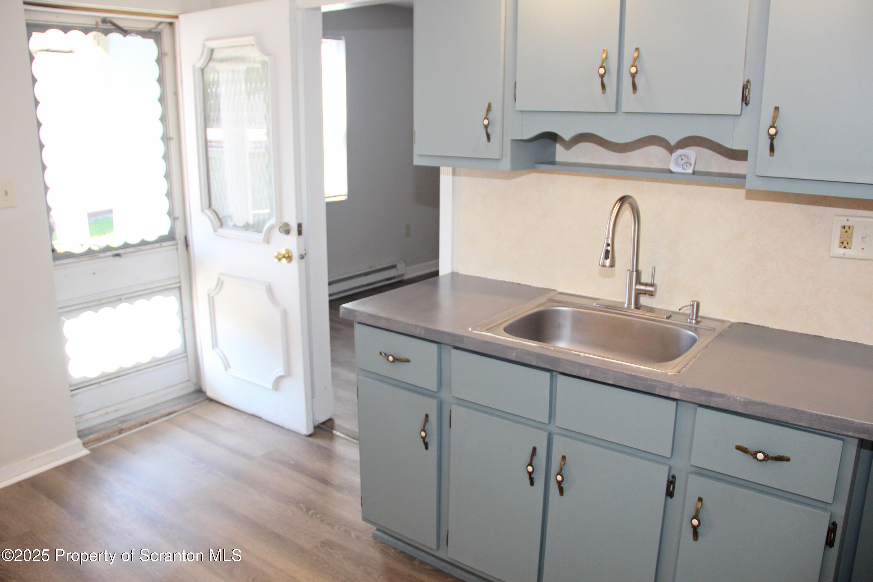 144 East Grace Street Old Forge, PA 18518 - Photo 15 of 17 a kitchen with stainless steel appliances granite countertop a sink and a white wooden cabinets