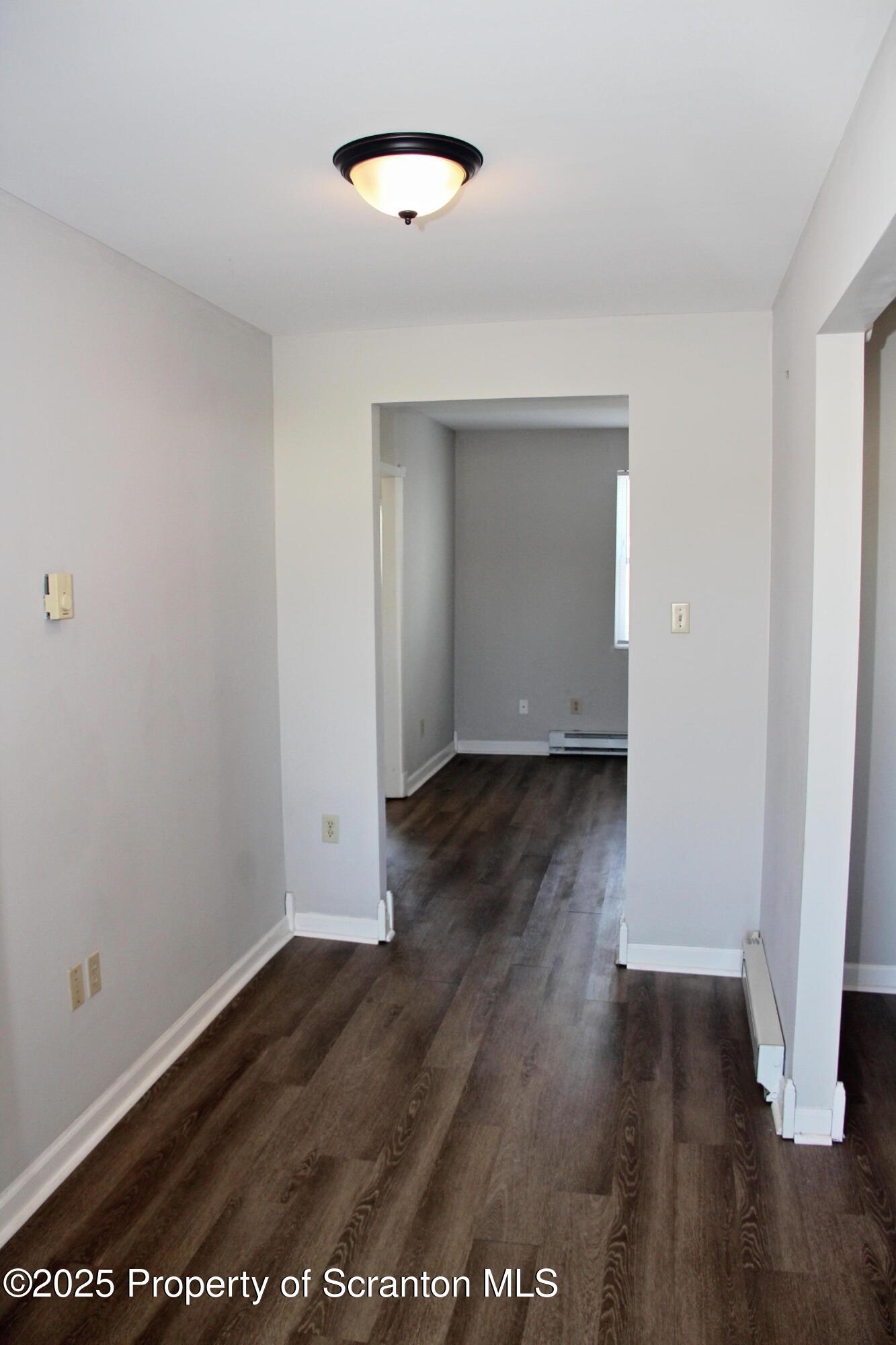 144 East Grace Street Old Forge, PA 18518 - Photo 4 of 17 an empty room with wooden floor and windows