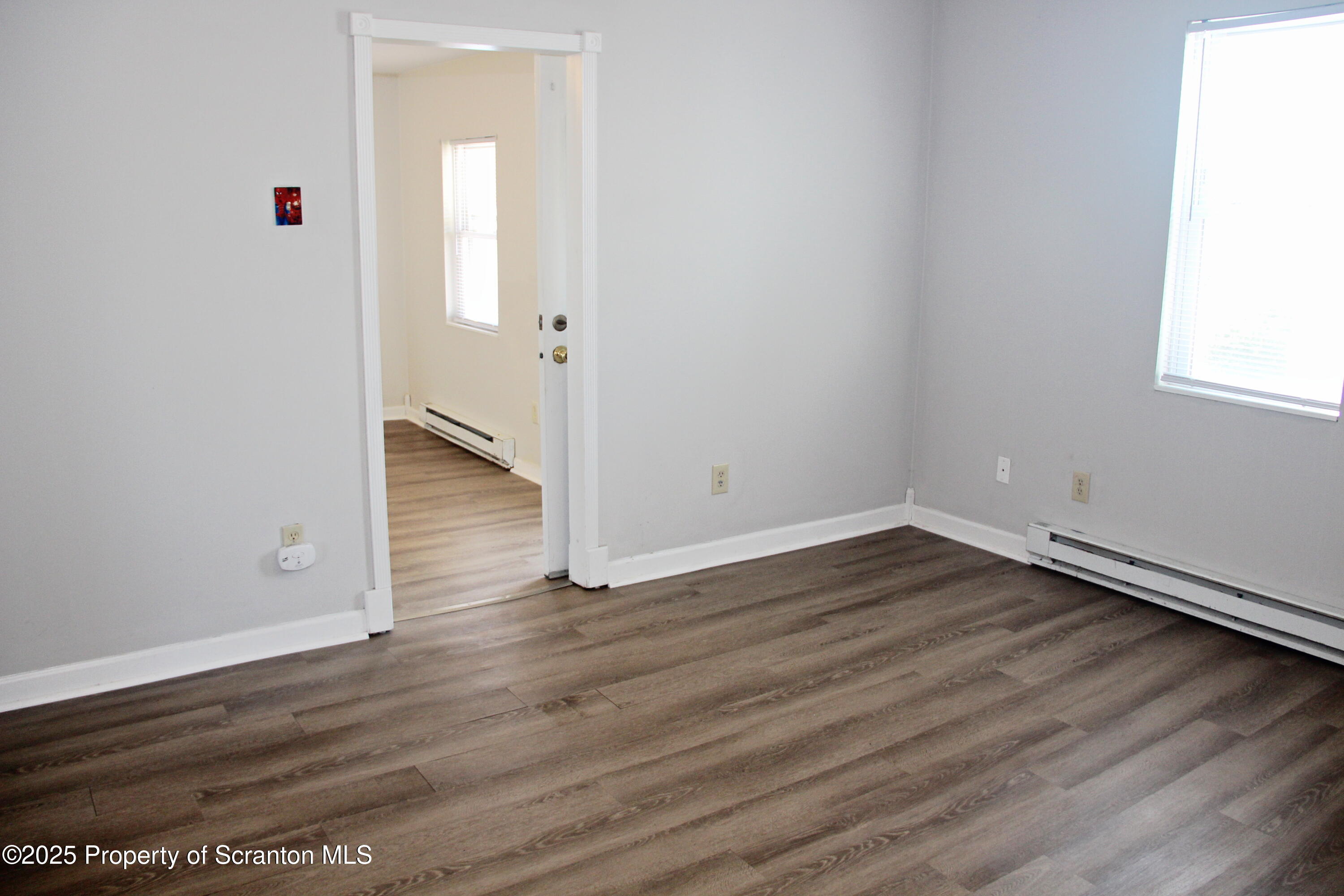 144 East Grace Street Old Forge, PA 18518 - Photo 10 of 17 an empty room with wooden floor & windows