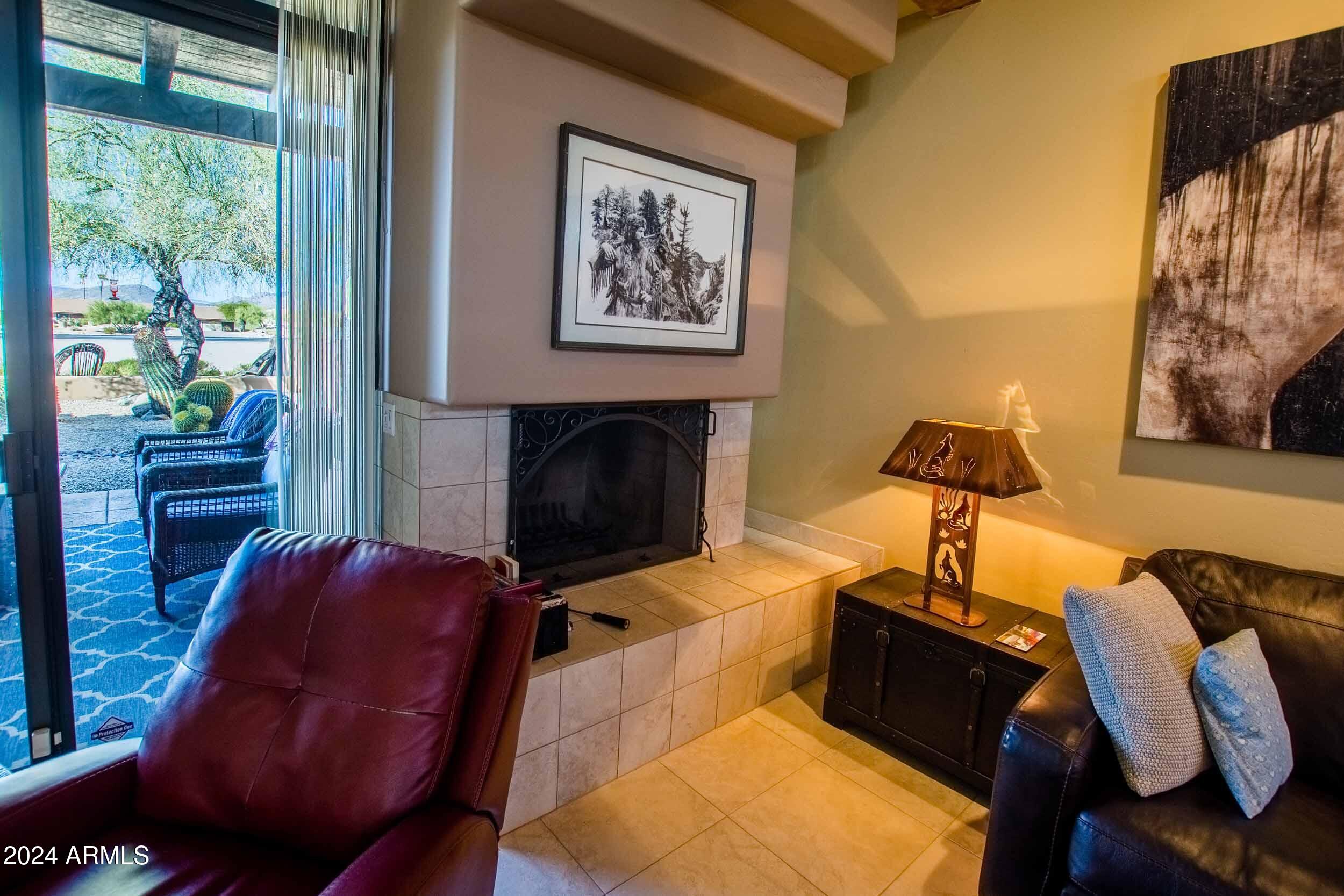 8502 East Cave Creek Road, Unit 10 Carefree, AZ 85377 - Photo 16 of 44 a living room with furniture and a fireplace