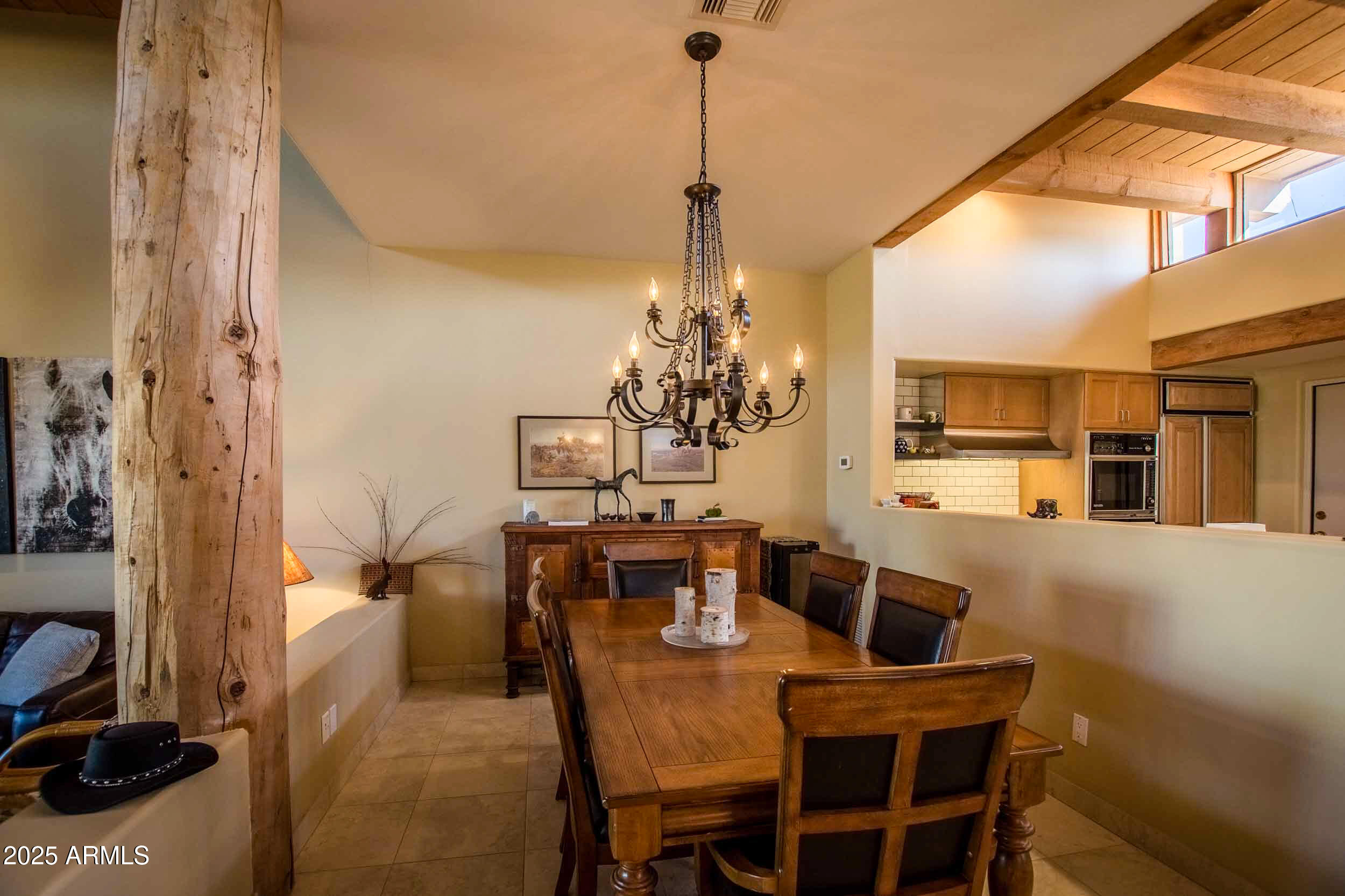8502 East Cave Creek Road, Unit 10 Carefree, AZ 85377 - Photo 19 of 44 a view of a dining room with furniture and chandelier