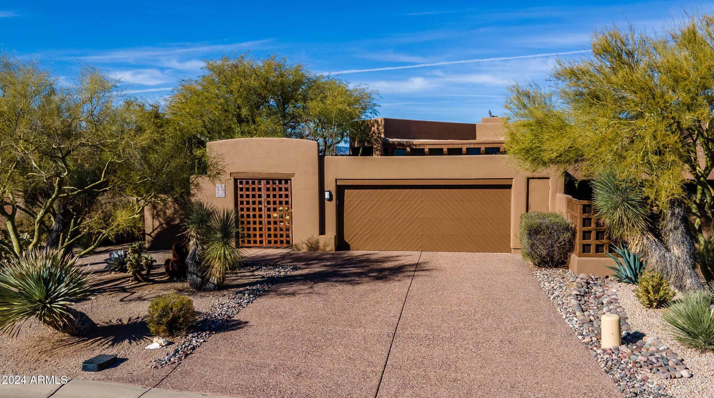 8502 East Cave Creek Road, Unit 10 Carefree, AZ 85377 - Photo 5 of 44 a view of a house with a yard and sitting area