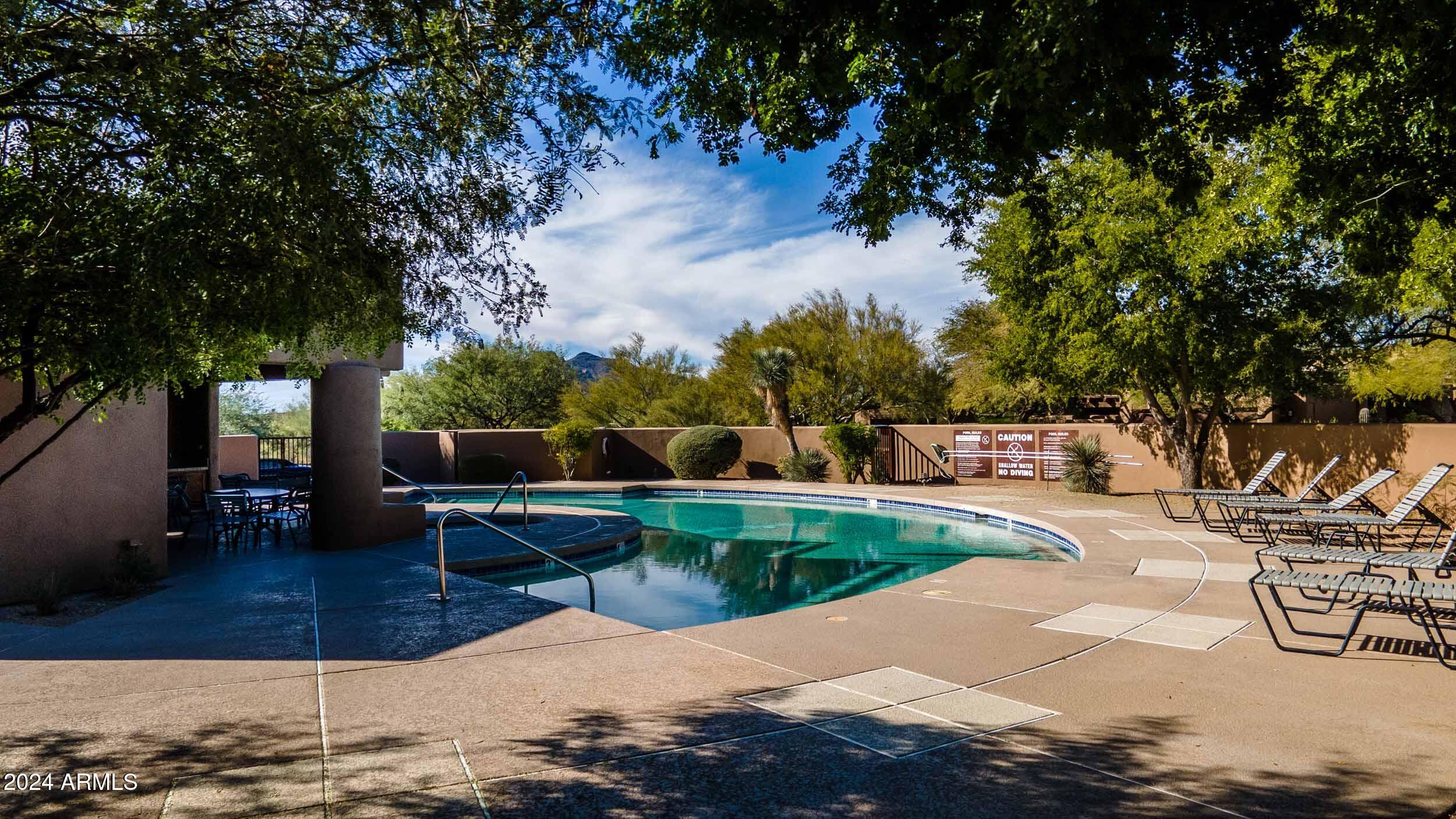 8502 East Cave Creek Road, Unit 10 Carefree, AZ 85377 - Photo 6 of 44 a view of a swimming pool with a patio