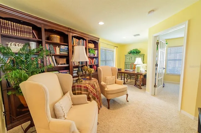 a living room with furniture and a floor to ceiling window