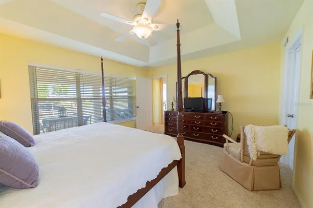 a bedroom with a large bed and a chandelier