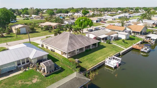an aerial view of a house with swimming pool patio and lake view