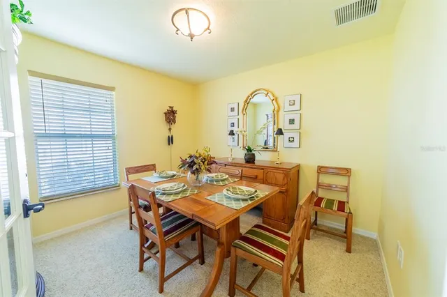 a view of a dining room with furniture and window