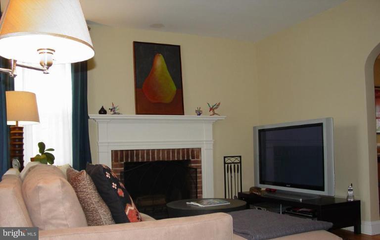 730 Overbrook Road Baltimore, MD 21212 - Photo 3 of 29 a living room with furniture a fireplace and a flat screen tv