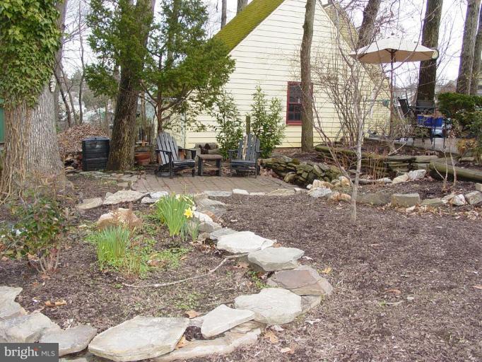 730 Overbrook Road Baltimore, MD 21212 - Photo 26 of 29 a backyard of a house with large trees and outdoor seating