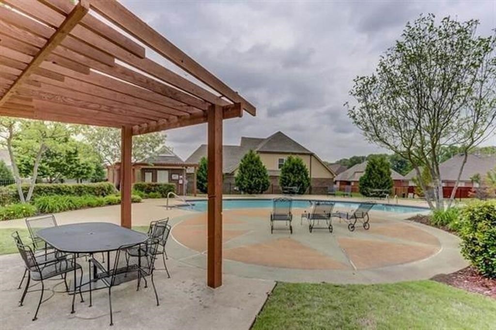 4597 Whisper Spring Drive Collierville, TN 38017 - Photo 38 of 39 a view of a patio with a table chairs and a backyard