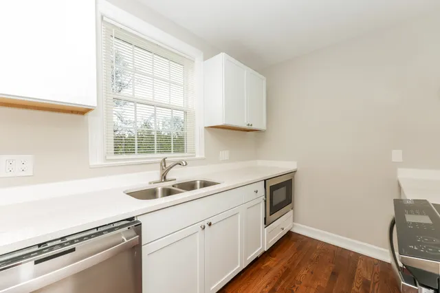 a kitchen with a sink and cabinets