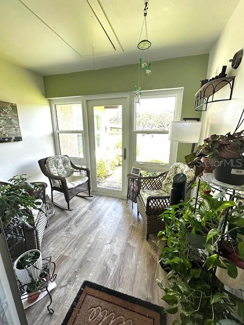 1701 Pinehurst Road, Unit 13C Dunedin, FL 34698 - Photo 18 of 28 a room with lots of potted plants and a chandelier