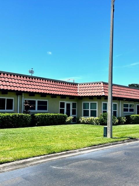1701 Pinehurst Road, Unit 13C Dunedin, FL 34698 - Photo 24 of 28 a front view of a house with a yard
