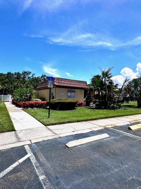 1701 Pinehurst Road, Unit 13C Dunedin, FL 34698 - Photo 25 of 28 a view of a patio with a garden