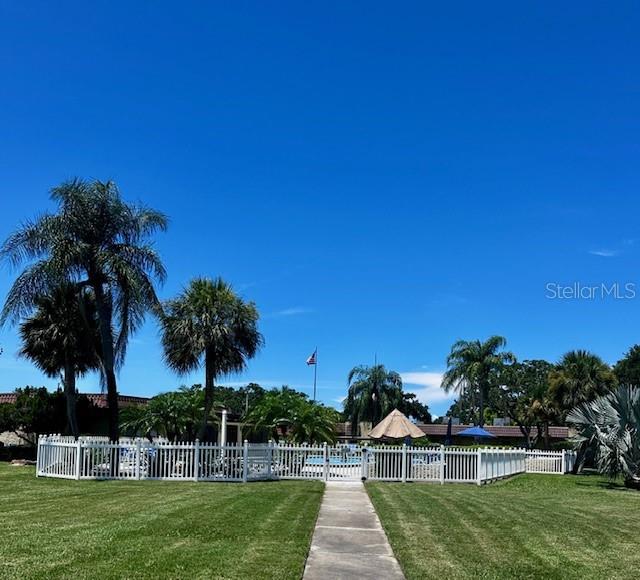 1701 Pinehurst Road, Unit 13C Dunedin, FL 34698 - Photo 26 of 28 a view of a house with a big yard plants and palm trees