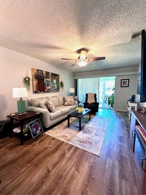 1701 Pinehurst Road, Unit 13C Dunedin, FL 34698 - Photo 3 of 28 a living room with furniture and a wooden floor