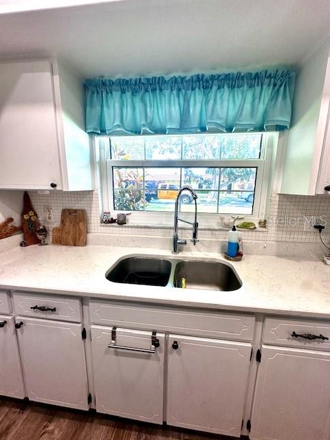 1701 Pinehurst Road, Unit 13C Dunedin, FL 34698 - Photo 7 of 28 a kitchen with kitchen island a sink a counter appliances and a window