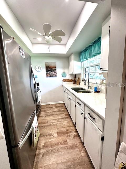 1701 Pinehurst Road, Unit 13C Dunedin, FL 34698 - Photo 9 of 28 a kitchen with white cabinets and white appliances