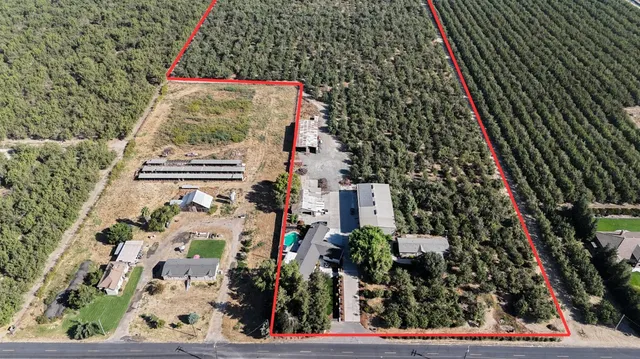 an aerial view of a house with a yard basket ball court and outdoor seating