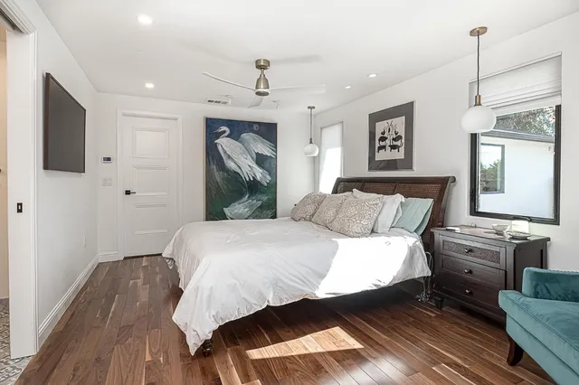 a bathroom with a granite countertop sink a toilet and a mirror