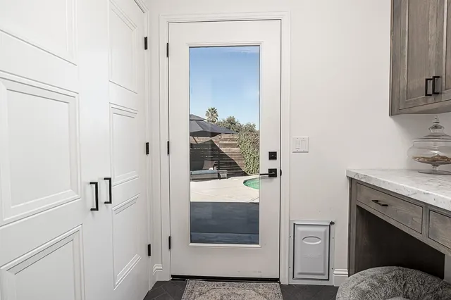 a bedroom with a bed and a dresser with mirror