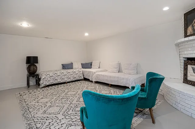 a view of a swimming pool with a lounge chairs in patio