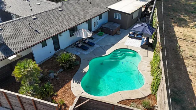 a view of a patio with table and chairs potted plants and a palm tree