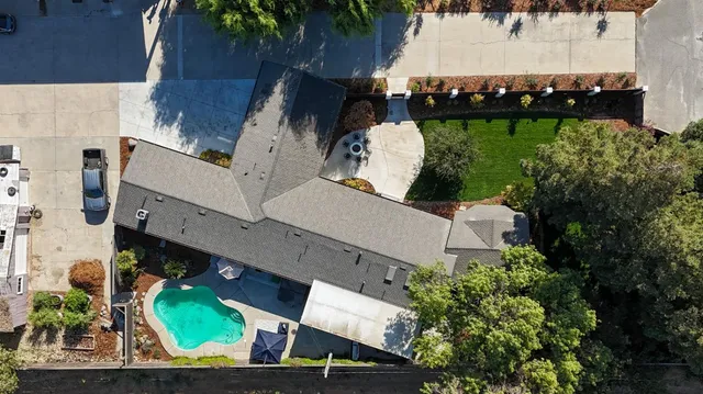 a view of a house with car parked in front of it