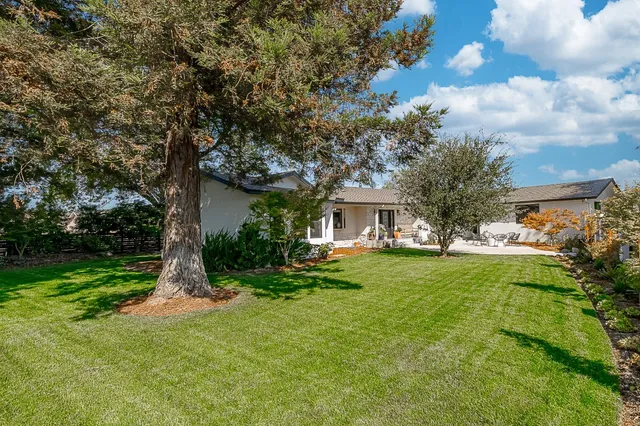 a view of a patio with table and chairs under an umbrella