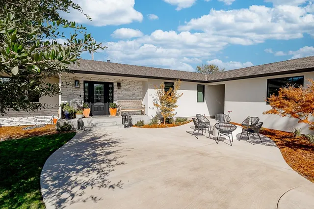 a front view of a house with outdoor seating