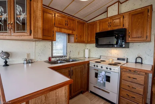 a kitchen with stainless steel appliances a stove microwave and sink