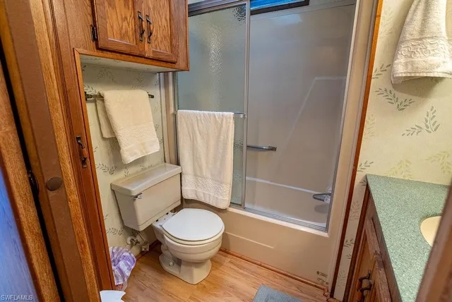 a bathroom with a toilet and a shower