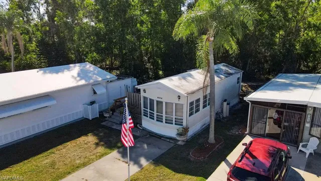 a view of a house with a bed and wooden deck