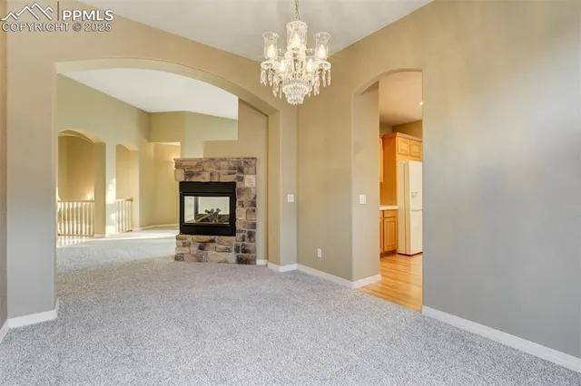 a view of a chandelier and a fireplace in a room