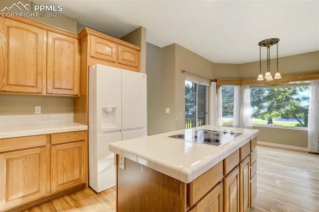 a kitchen with a sink cabinets and wooden floor
