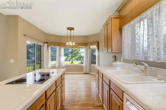 a kitchen with stainless steel appliances a sink stove and cabinets
