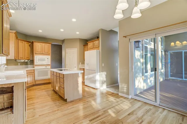 a large kitchen with a large counter top and stainless steel appliances