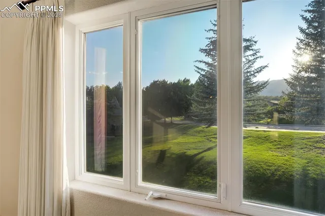 a view of a glass door and a yard