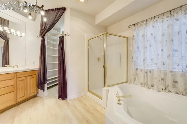 a bathroom with a granite countertop sink a bathtub and a shower