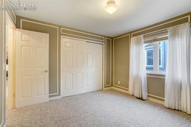 an empty room with windows and closet