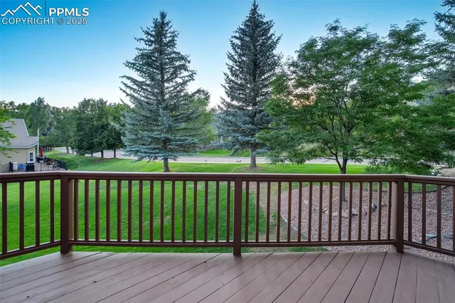 a view of balcony with wooden floor and fence