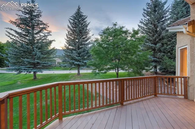 a view of a wooden deck and a yard