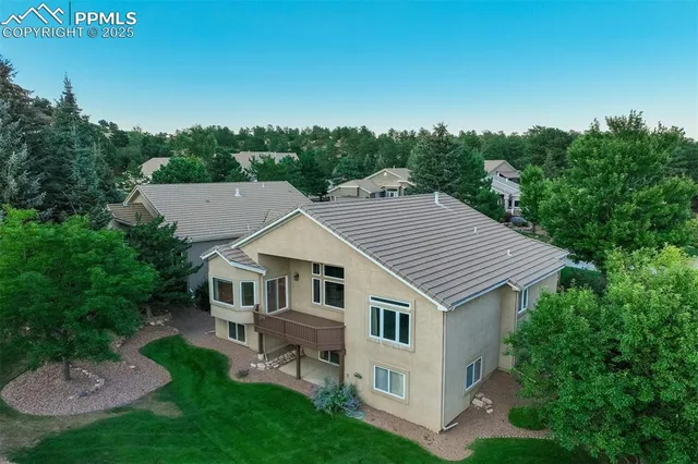 an aerial view of a house with a yard