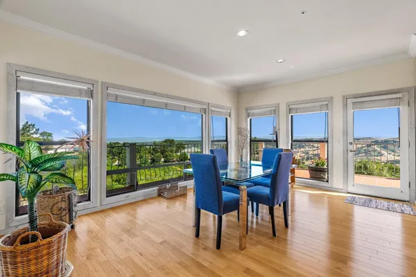 a view of a dining room with furniture window and wooden floor