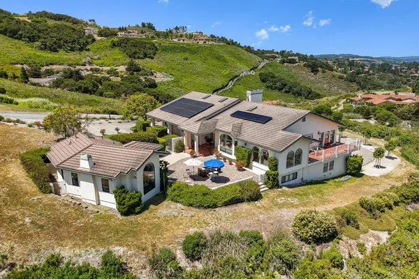 an aerial view of a house with a big yard